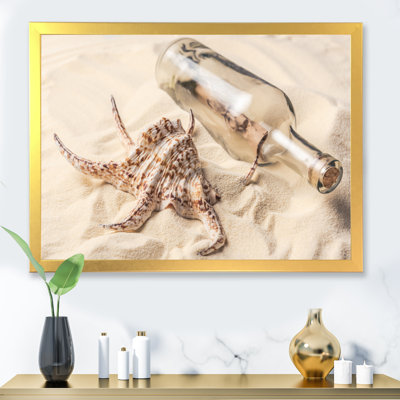" Seashell And Bottle With Letter On Sandy Beach "