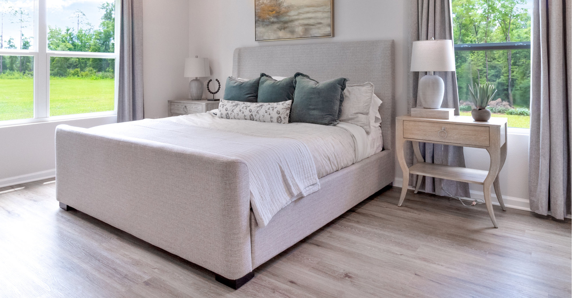 Bedroom with upholstered bed and matching nightstands.