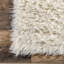 Tapis à poil long en laine Nemya-89723703