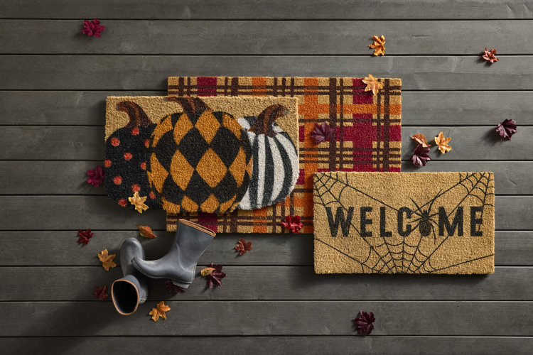 front porch a three different Halloween-themed doormats