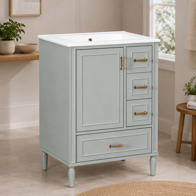 Meuble-lavabo moderne vert sauge de 61 cm (24 po) avec lavabo en céramique, portes et tiroirs à fermeture amortie, poignées dorées et tablette de porte.