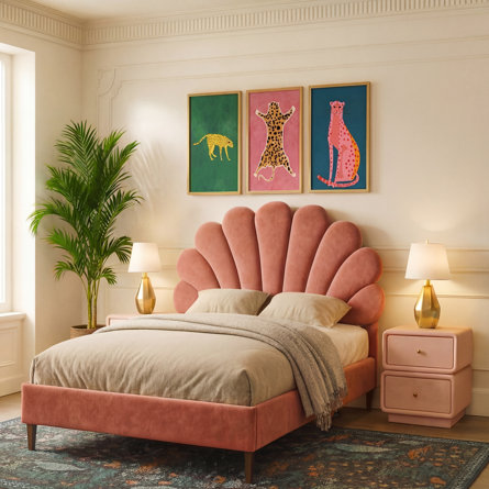 Bedroom with shell bed, framed leopard prints, and tropical plant