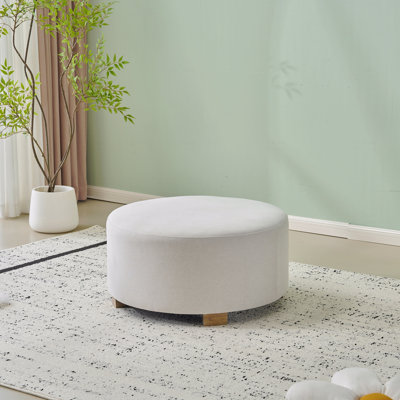 Repose-pieds rond rembourré en tissu avec pieds en bois, style minimaliste moderne