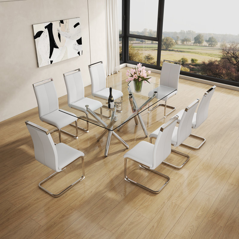 Ensemble de table de salle à manger moderne Daarina, grande table rectangulaire en verre avec base en X argentée et chaises en porte-à-faux en similicuir