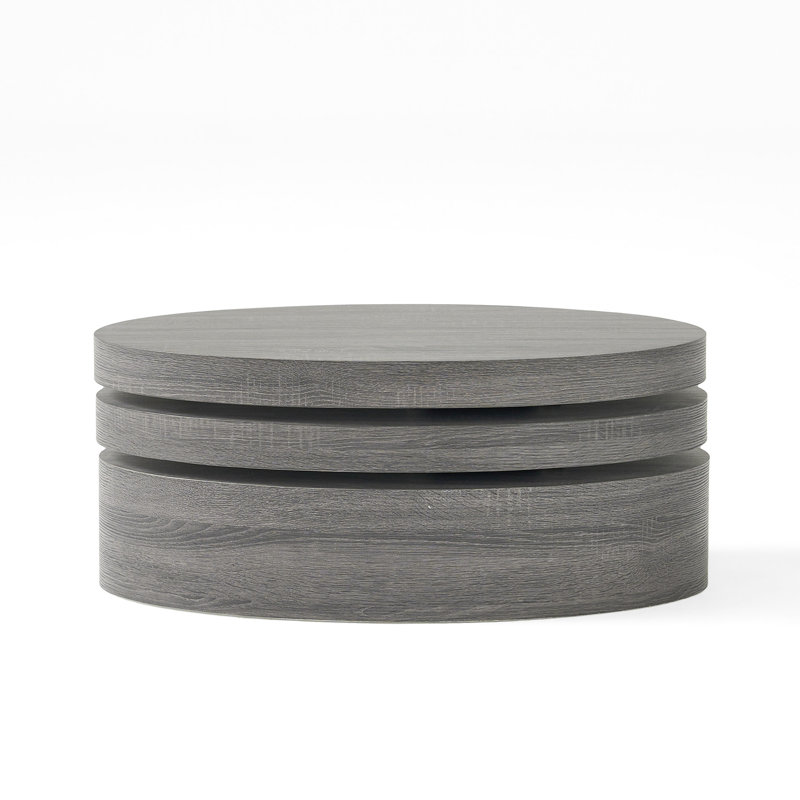 Table basse ovale rotative avec des couches et des surfaces d'aspect contemporain