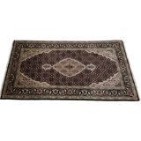 Nivethan Oriental Area Rug in Beige