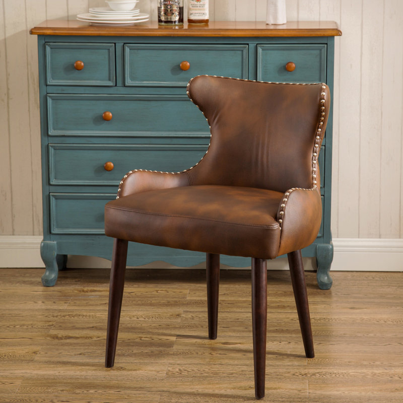Fauteuil demi-tonneau capitonné à dossier capitonné