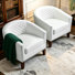 Fauteuil demi-tonneau capitonné en similicuir Edvardas