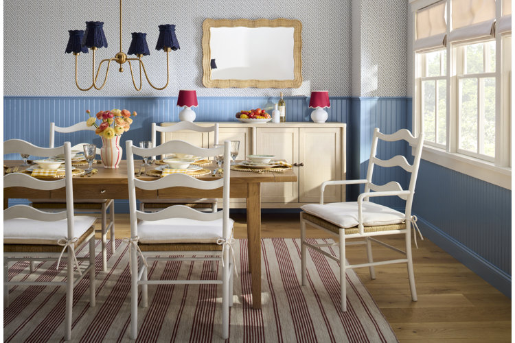 cozy dining room ideas a cottage style dining room with a wooden dining table white wooden dining chairs and a cream colored buffet table with blue paneling and blue wallpaper