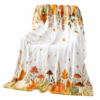 Couverture polaire douce et moelleuse à motif citrouilles et champignons, idéale pour canapé, lit et décor d'automne.