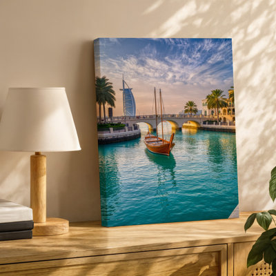 Canvas A Stunning View Of A Luxurious Waterfront Scene In Dubai Wall Art Featuring A Traditional Wooden Dhow Boat Gliding Gracefully Canvas Wall Art