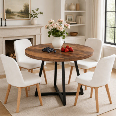 Table de salle à manger ronde et élégante au design industriel vintage, idéale pour les petits espaces et les repas en petit comité.