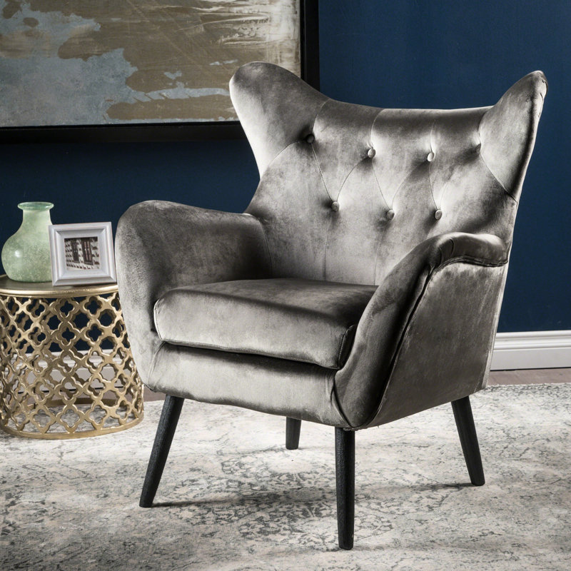 Le fauteuil à oreilles gris en velours offre une solution d'assise élégante avec un siège confortable, Gris