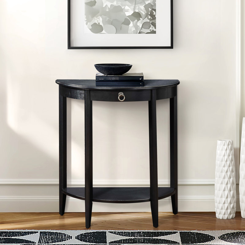 Table basse noire en demi-lune avec tablette inférieure, peu encombrante pour le salon