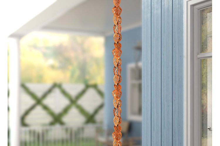 copper leaf design rain chain hanging from a gutter on the porch of a home