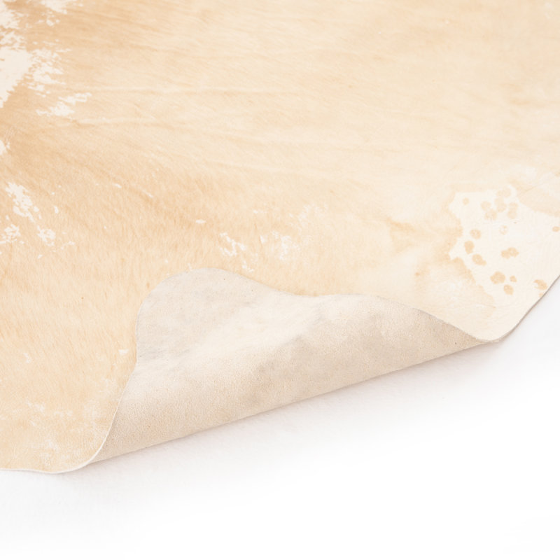 Harland Cowhide Animal Print Area Rug in Ivory