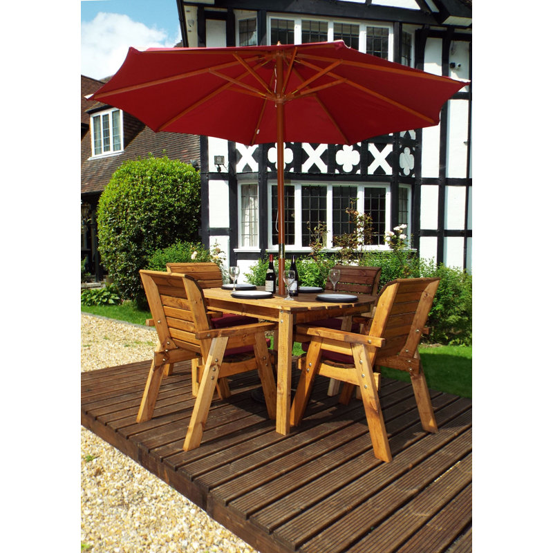 Feldman 4 - Person Wood Patio Dining Set with Rectangular Table , Cushions Included, Burgundy