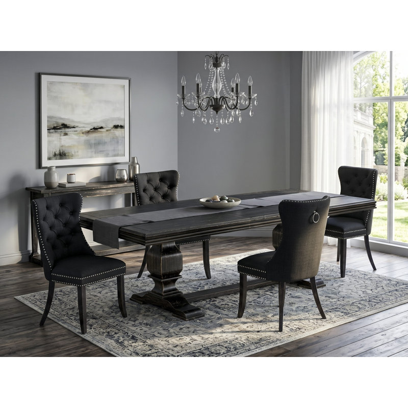5-piece modern dining set consists of a dining table and 4 Black Polyester Fabric padded Chairs with Button Tufted Chair Back - Sand Blasting Black Finish.