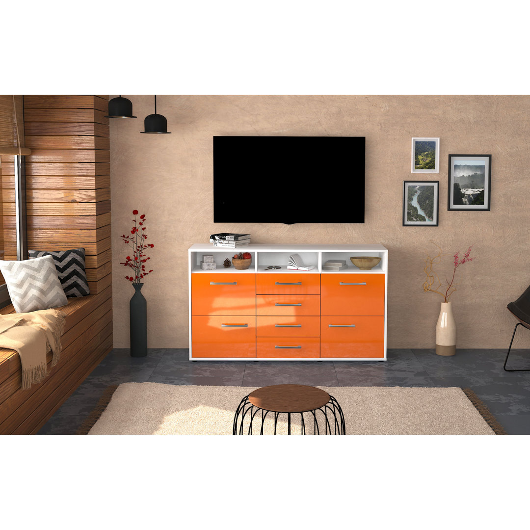 Das Sideboard Donabella hat einen weißen Korpus und eine orange Hochglanzfront. Es misst 136 cm x 79 cm x 35 cm und verf...