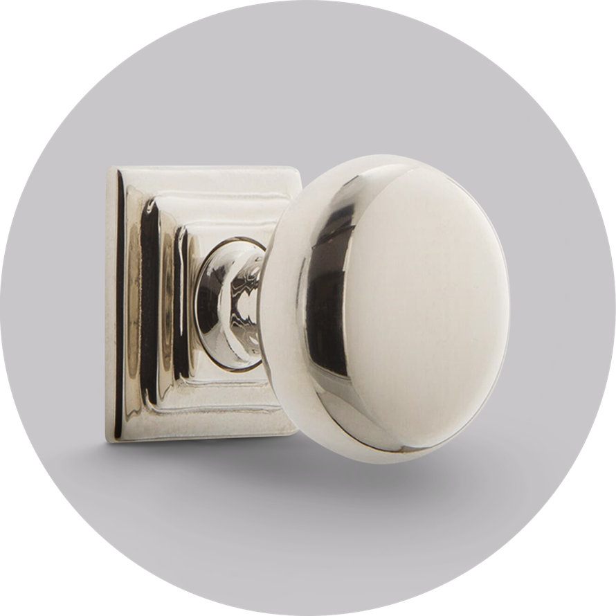 Polished nickel door knob with a round handle and square mounting plate.