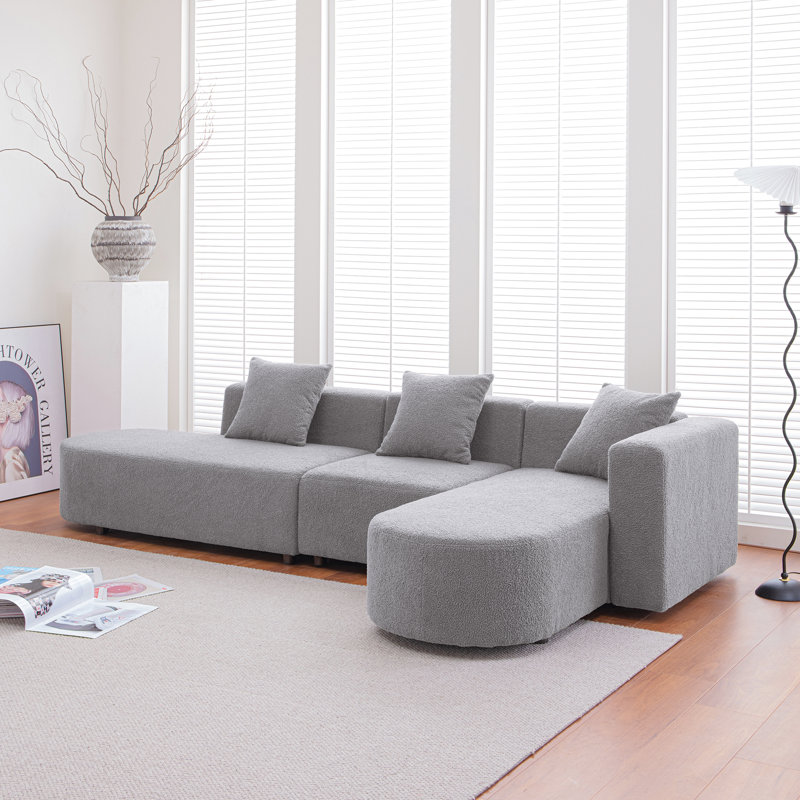 Espace de vie moderne avec siège incurvé faisant face à la droite - Modulaire gris doux