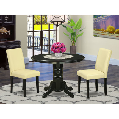 3 Piece Dinette Set for Small Spaces Contains a Round Kitchen Table with Pedestal and 2 Eggnog Faux Leather Parsons Dining Chairs, Black