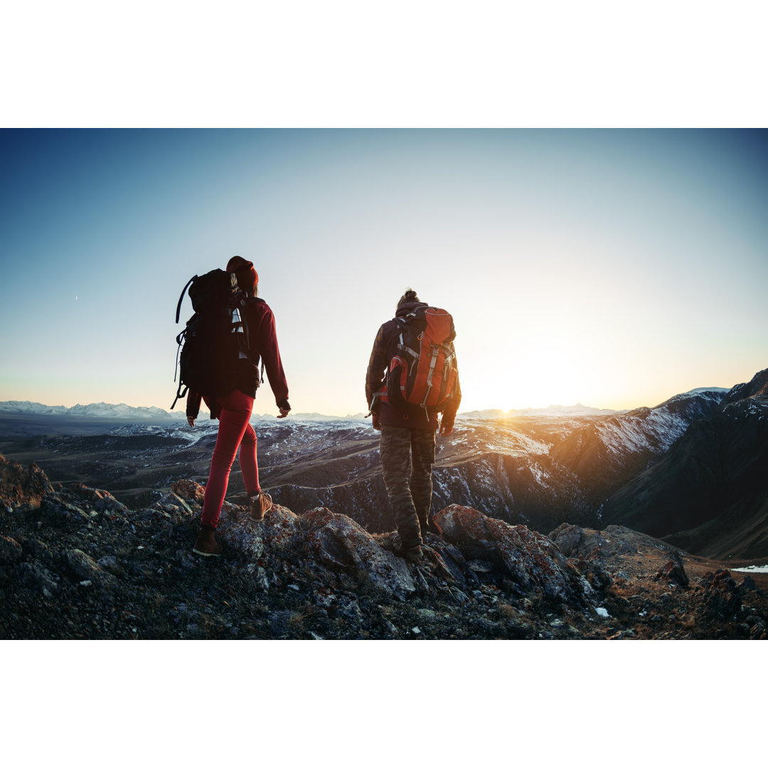 Leinwandbild Two Hikers Walk Sunset Mountains