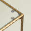 Table basse moderne en verre avec cadre en métal doré