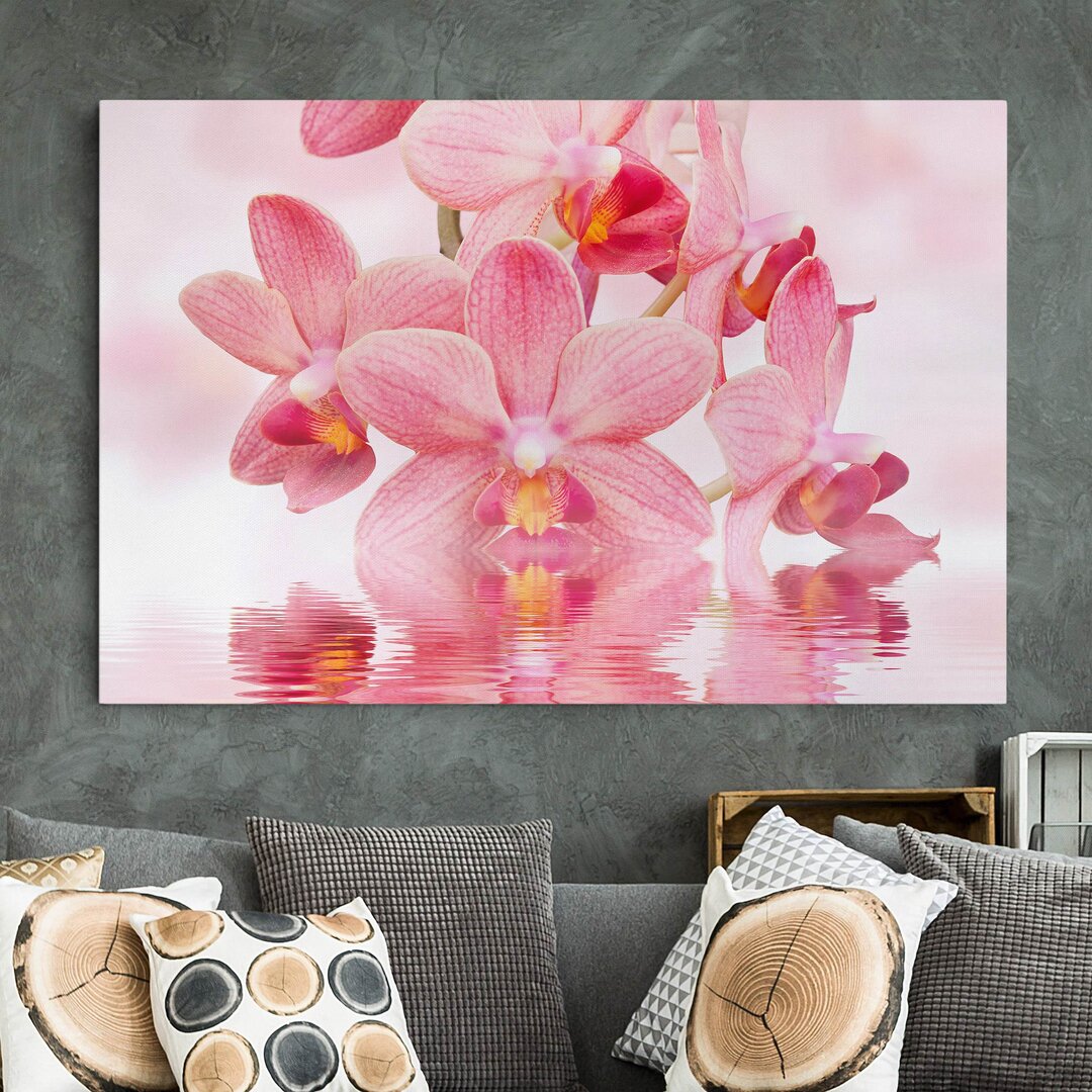 Leinwandbild Rosafarbene Orchideen auf Wasser