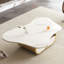 Table basse ovale en pierre frittée de ton blanc avec tiroir de rangement et tablette, design papillon moderne pour le salon