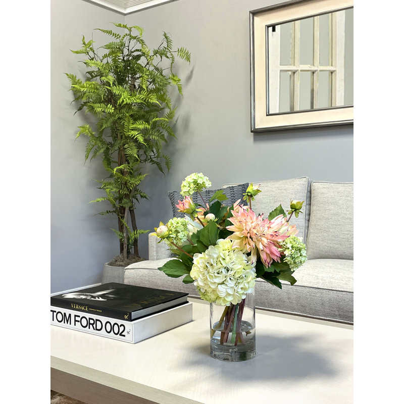 Darla Dahlia, arrangement d'hortensias et de protées dans un vase en verre