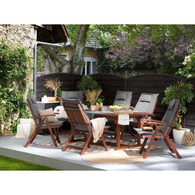 Brodbeck 6 - Person Acacia Solid Wood Patio Dining Set Extendable and Umbrella Hole Included Rectangular Table with Cushions Included