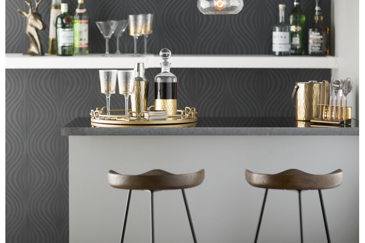 home bar with 2 stools, gold tray and gold shaker and decanter