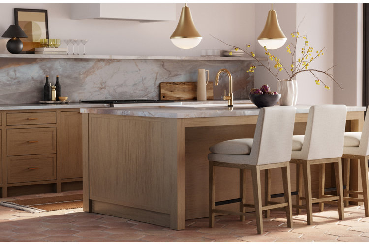 Kitchen with terracotta tile floors, large wood kitchen island with white marble countertops, and three white counter stools.
