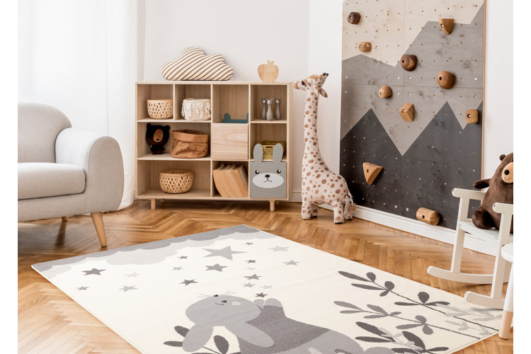 modern kids playroom with a gray, white, and light wood color scheme and an indoor climbing wall