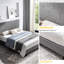 Lit tapissier grand, gris, avec support de lit en lattes de bois gris, offrant un confort optimal