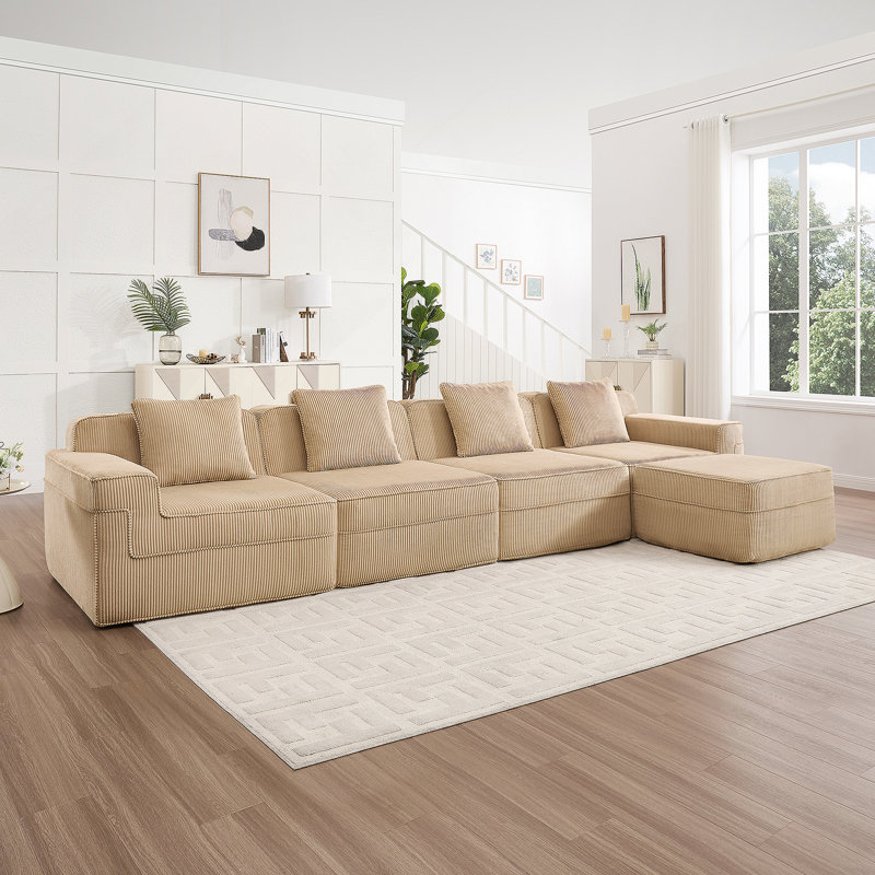 Canapé modulaire moderne en L à 4 places avec sièges profonds, coussins décoratifs et repose-pieds mobile pour un confort et une polyvalence ultimes