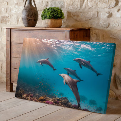 Canvas A Serene Underwater Scene Featuring A Group Of Four Dolphins Wall Art Gracefully Swimming Through Crystal Clear Turquoise Canvas Wall Art