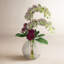 Orchid And Sedum Arrangement In Glass Vase