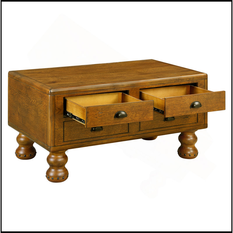 Table basse rectangulaire en bois massif exquis avec 4 tiroirs et pieds décoratifs à rivets, idéale pour divers espaces.