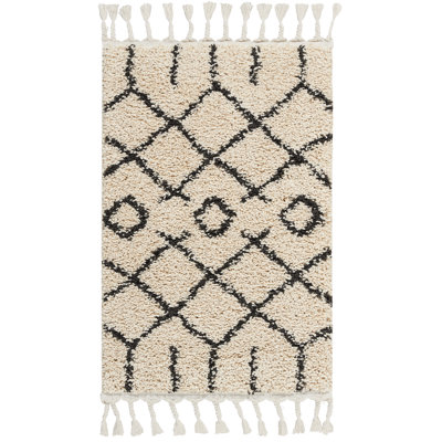 Tapis géométrique ivoire / noir en polypropylène tissé à la machine