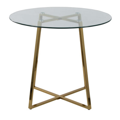 Table de salle à manger contemporaine avec plateau en verre trempé transparent et structure en métal doré pour une salle à manger élégante et peu encombrante.