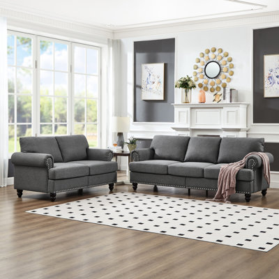 Canapé en tissu 5 places moderne et classique pour le salon, revêtement en gris, rond avec clous argentés, structure en bois massif, coussins amovibles, rangement sous les sièges, clous, structure