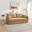 Canapé en tissu chenille texturé beige avec coussins décoratifs