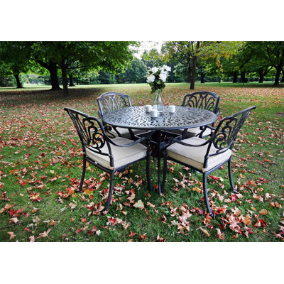 Annecorinne 4 - Person Patio Dining Set with Round Table , Cushions Included