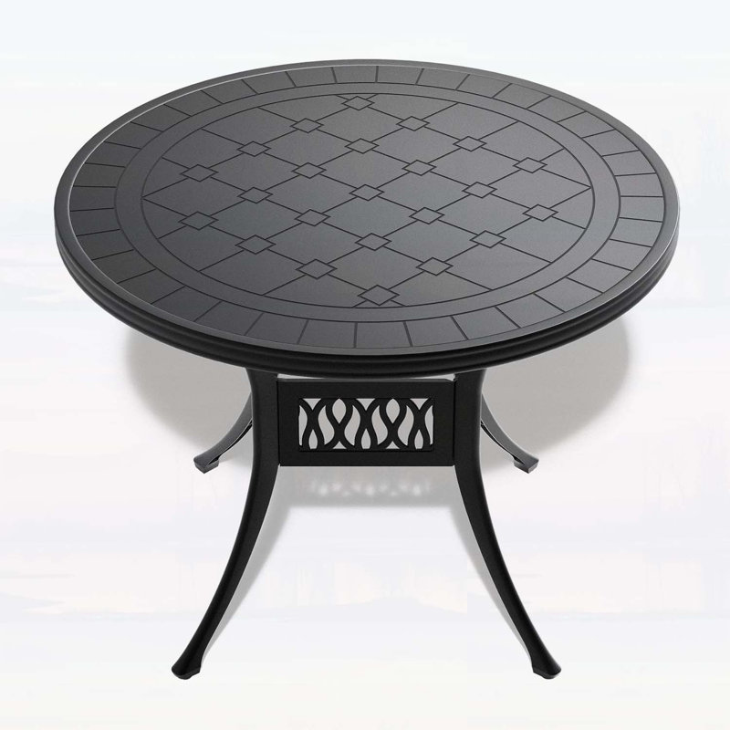Table de salle à manger en fonte d'aluminium avec texture sculptée élégante et cadre noir résistant aux intempéries pour une utilisation extérieure