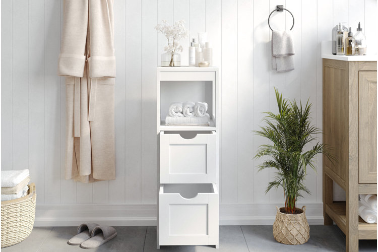 bright modern bathroom with white vertical storage cabinet holding towels and toiletries