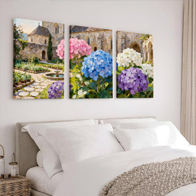 Ensemble de 3 tableaux sur toile tendue représentant un jardin d'hortensias avec une église en pierre