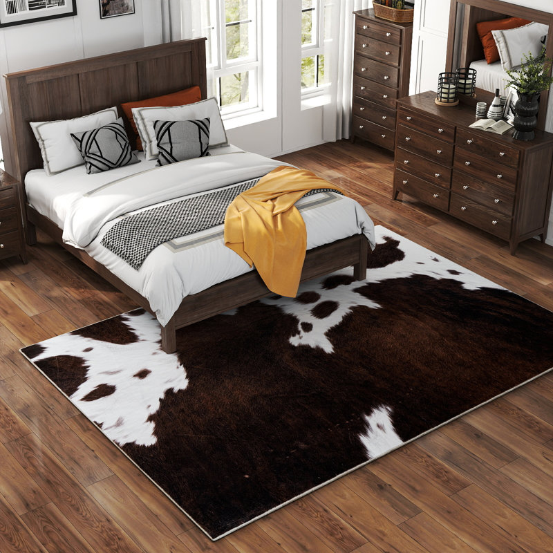 Dark brown cowhide-textured modern non-slip indoor area rug, machine washable and foldable, suitable for living rooms, hotels, apartments, and dormitories.