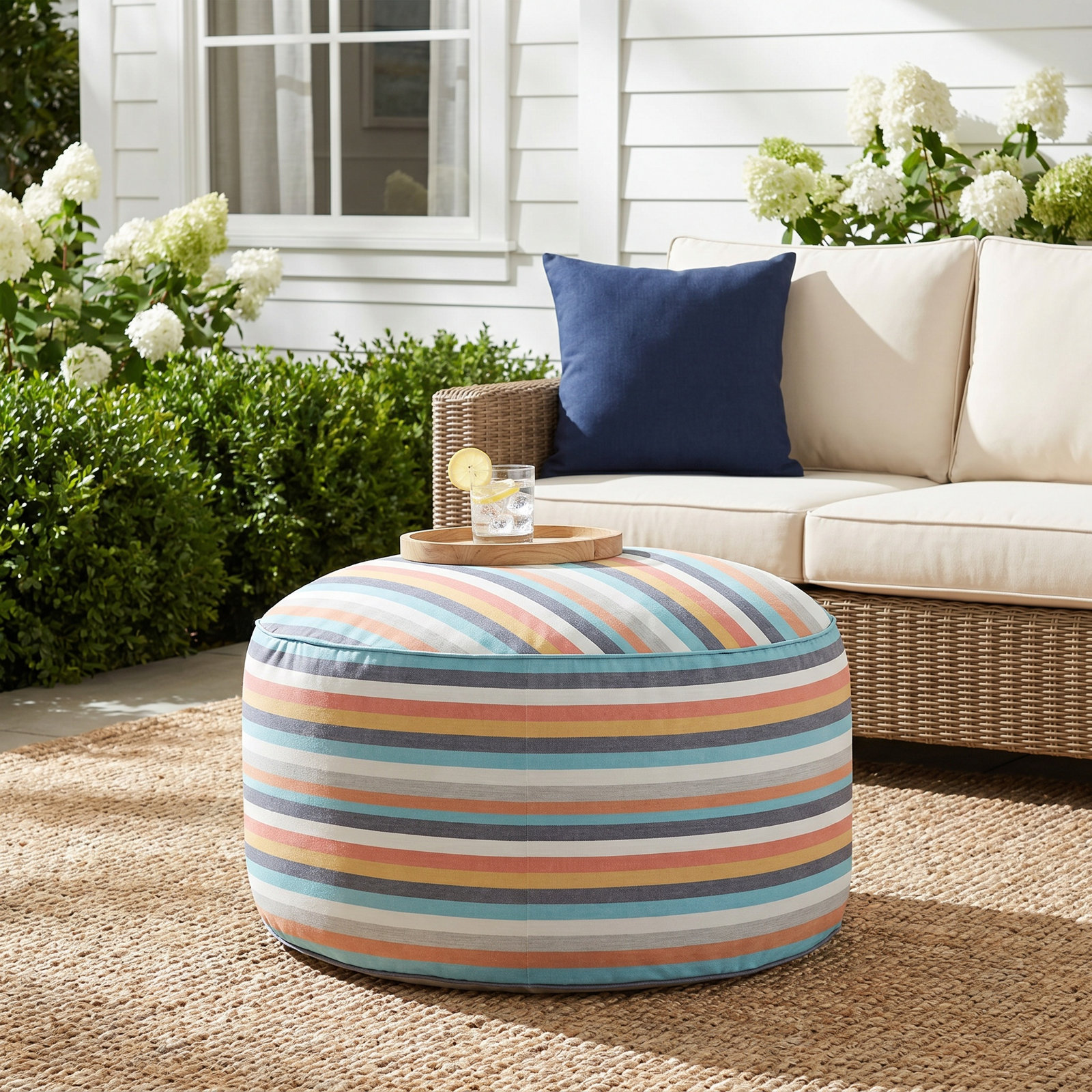 Harrah Round Upholstered Outdoor Ottoman with Sunbrella® Cushion